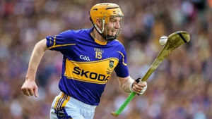 Sliotars in various sizes and colours displayed on grass – from First Touch to senior match balls, available at Lar Corbett Sports